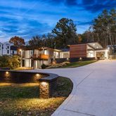 a view of a house with pool and sitting area