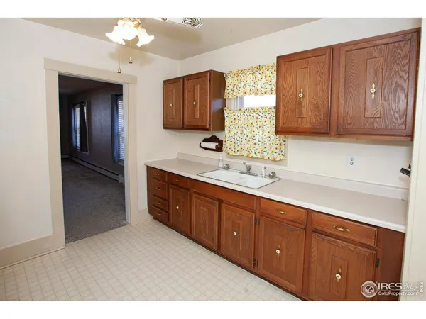 a kitchen with a refrigerator and a sink