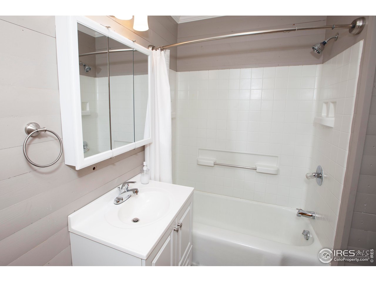 323 Cleveland Street Sterling, CO 80751 - Photo 15 of 28 a bathroom with a sink mirror and vanity