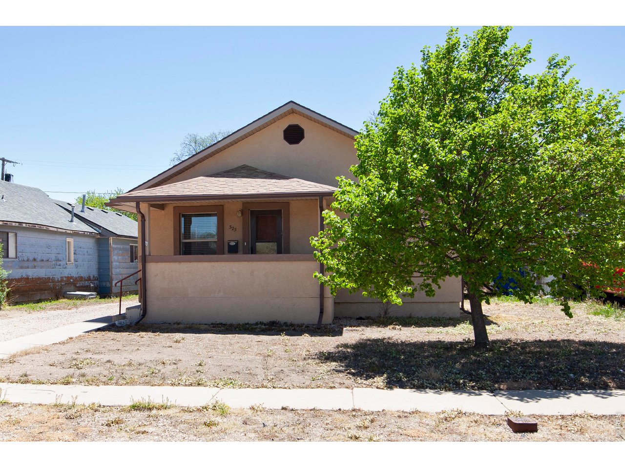 323 Cleveland Street Sterling, CO 80751 - Photo 2 of 28 a front view of a house with a yard
