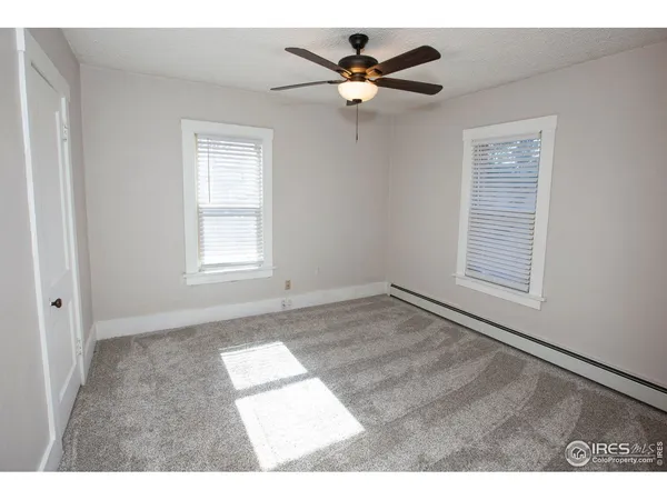 a view of an empty room with a ceiling fan