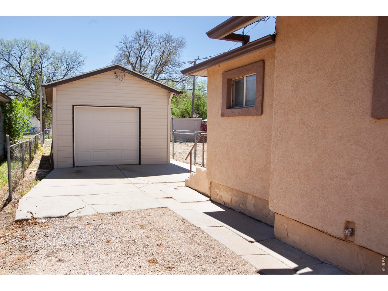 323 Cleveland Street Sterling, CO 80751 - Photo 25 of 28 a front view of a house with a yard and garage