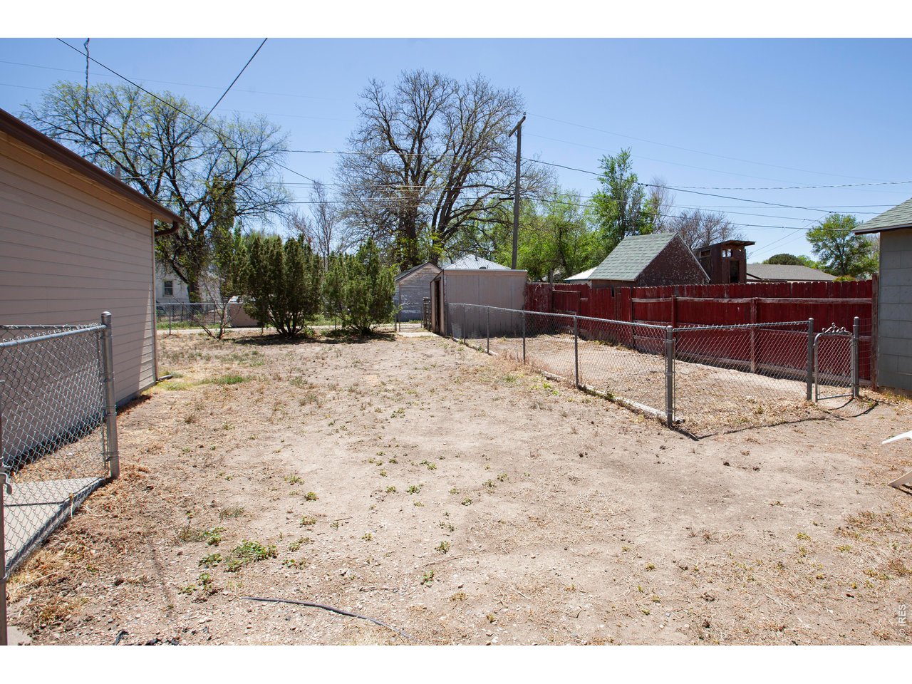 323 Cleveland Street Sterling, CO 80751 - Photo 27 of 28 a view of a backyard with a bench