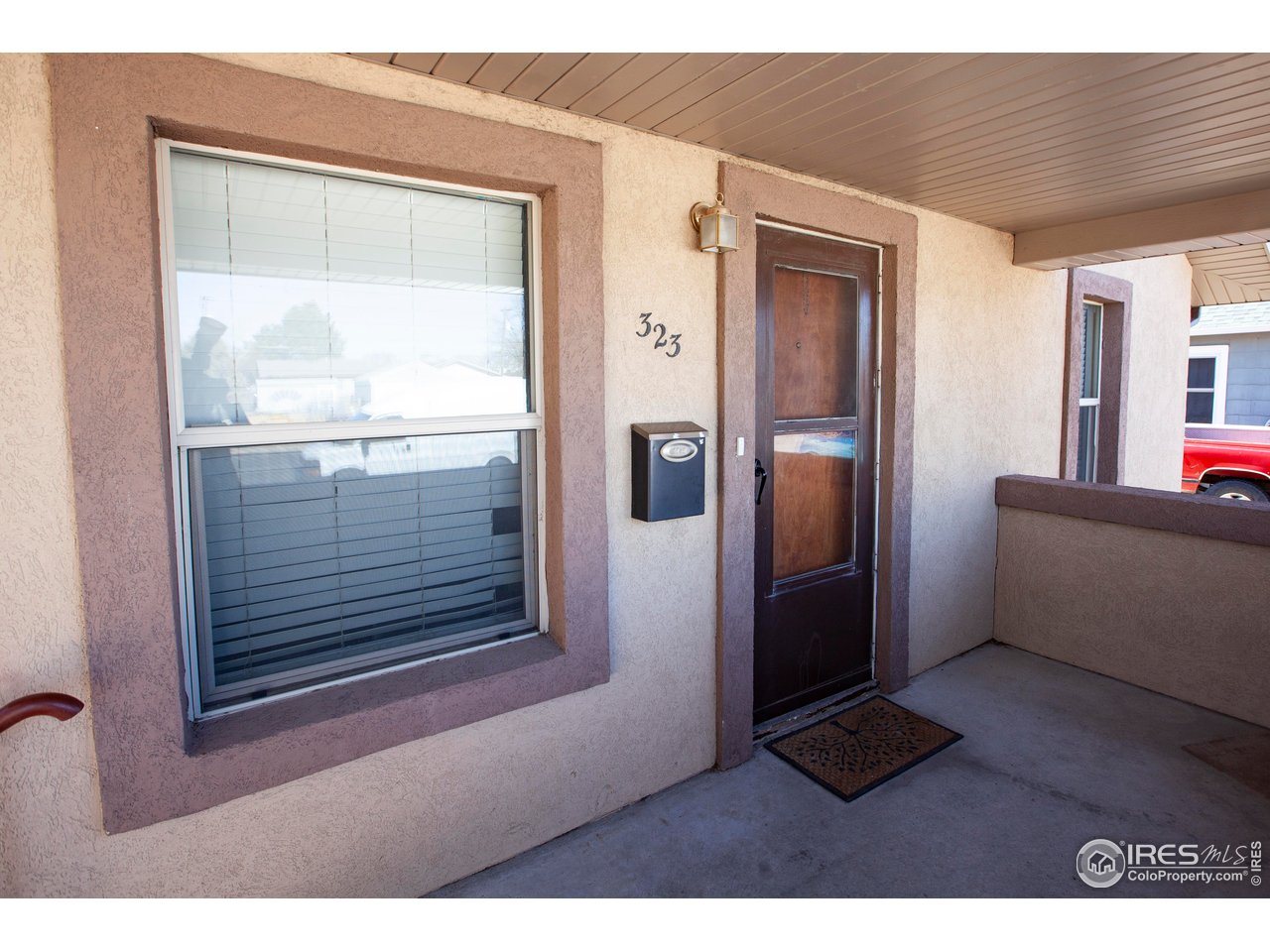 323 Cleveland Street Sterling, CO 80751 - Photo 3 of 28 a view of an empty room with wooden floor and a window