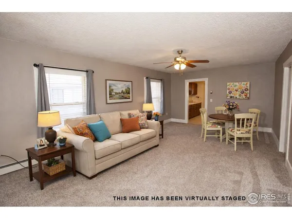 a living room with furniture a chandelier and a window