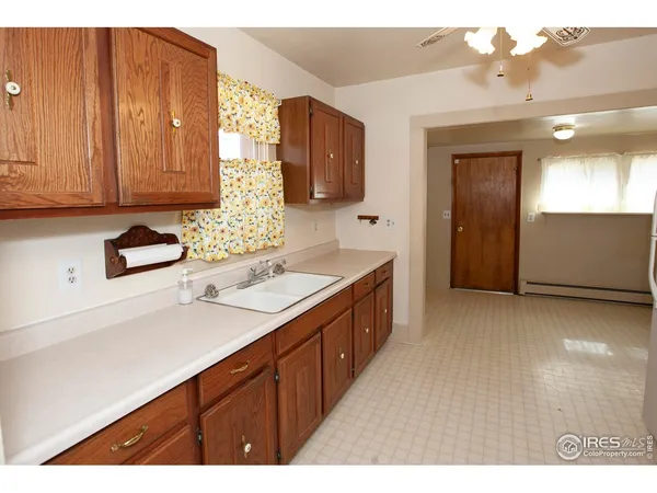 a kitchen with kitchen island a counter top space appliances and cabinets
