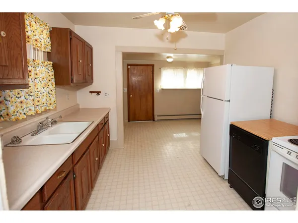 a kitchen with refrigerator and cabinets