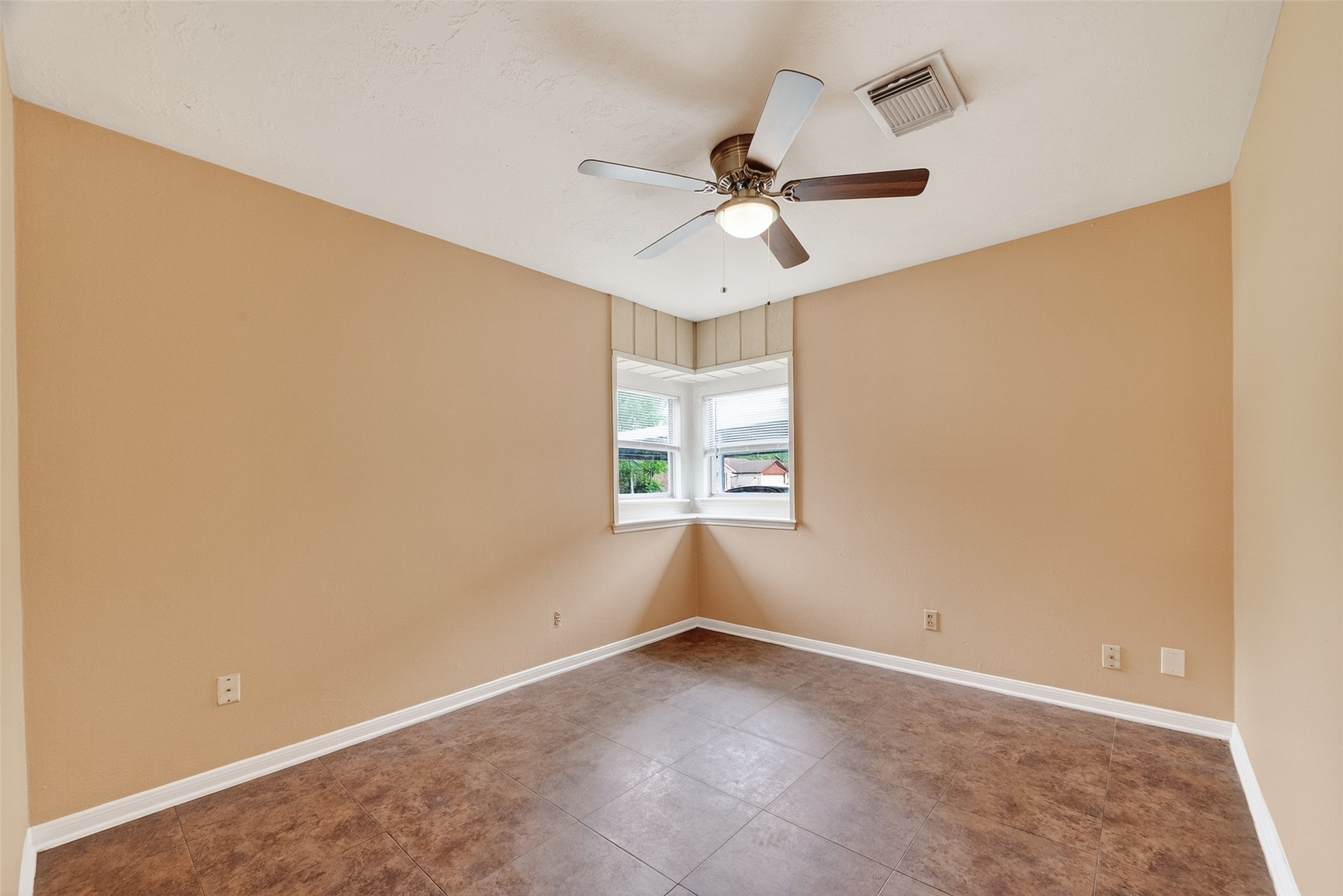 4826 Redfish Reef Drive Bacliff, TX 77518 - Photo 4 of 25 an empty room with windows and fan