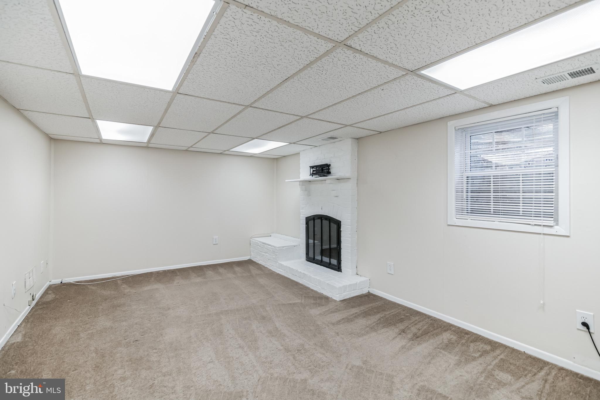 8331 Moline Place Springfield, VA 22153 - Photo 22 of 31 Rec room with wood burning fireplace