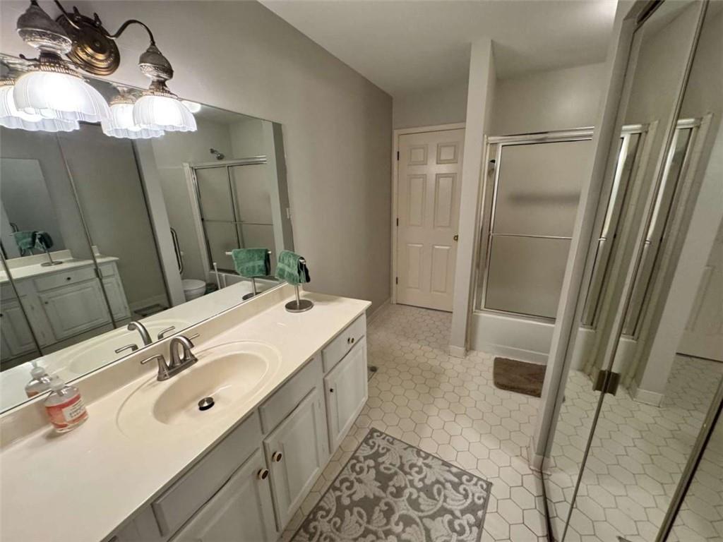 3201 Lenox Road Northeast, Unit 2 Atlanta, GA 30324 - Photo 16 of 39 a spacious bathroom with a double vanity sink mirror and shower