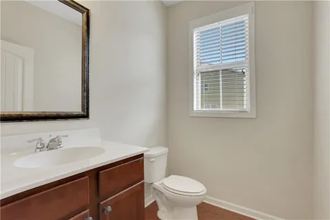 a bathroom with a sink vanity granite and toilet