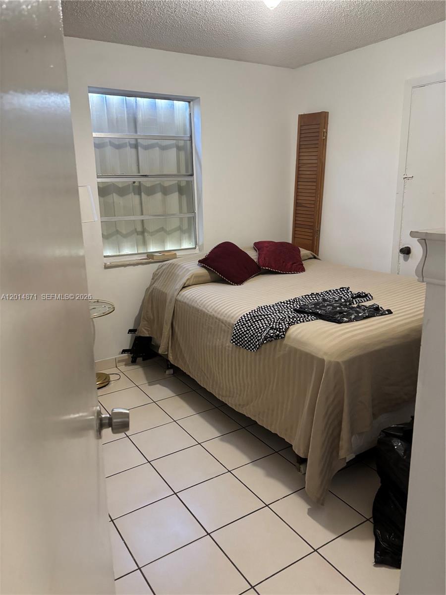 116 Allen Road West Park, FL 33023 - Photo 14 of 15 a bedroom with a bed and a window