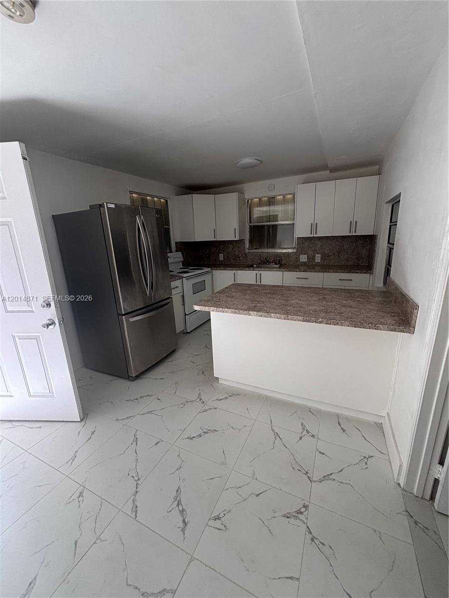 116 Allen Road West Park, FL 33023 - Photo 2 of 15 a kitchen with stainless steel appliances granite countertop a refrigerator sink and stove