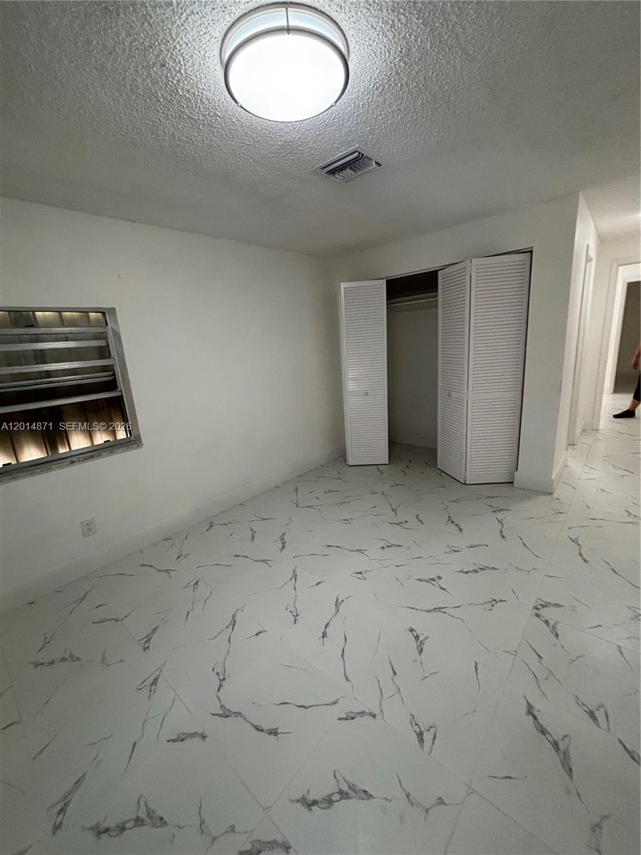 116 Allen Road West Park, FL 33023 - Photo 6 of 15 an empty room with windows