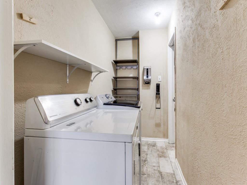 1106 Ridgeway Circle Richardson, TX 75080 - Photo 17 of 25 Laundry room with a textured wall, light wood finished floors, and washer and clothes dryer