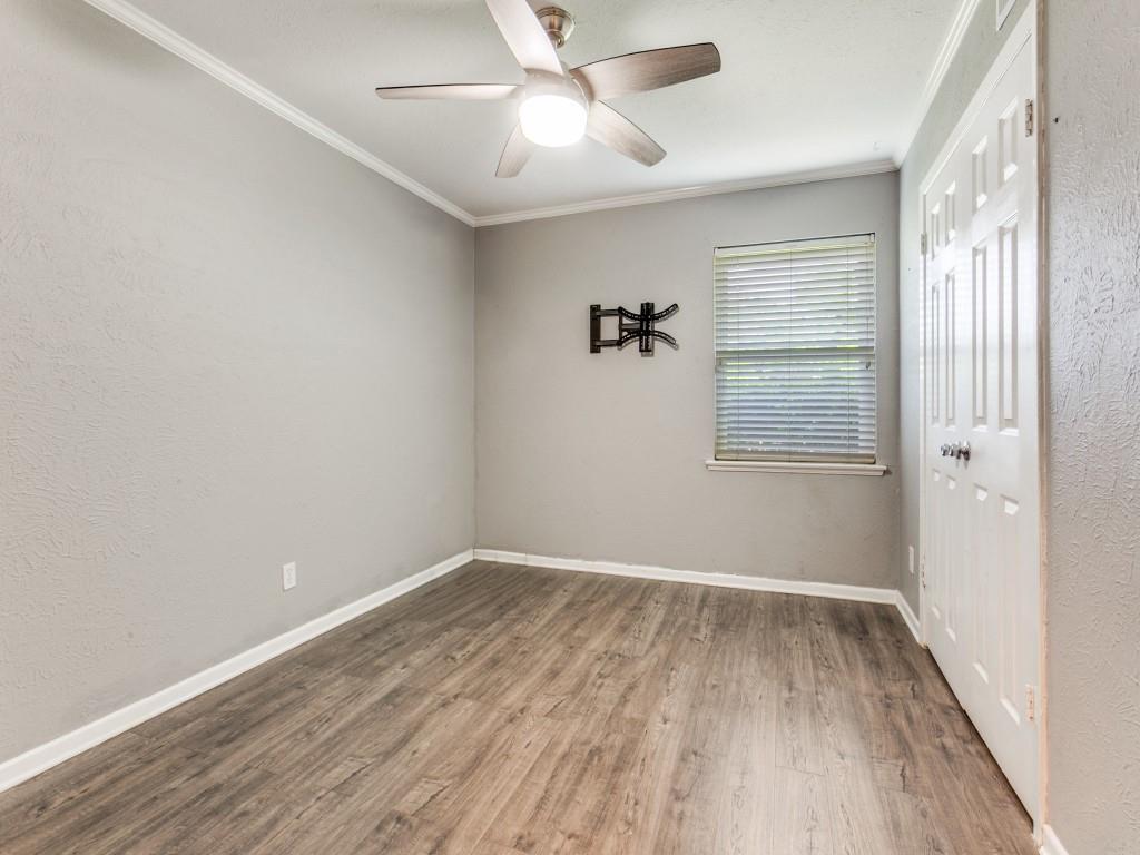 1106 Ridgeway Circle Richardson, TX 75080 - Photo 20 of 25 Spare room featuring crown molding, a textured wall, wood finished floors, and a ceiling fan