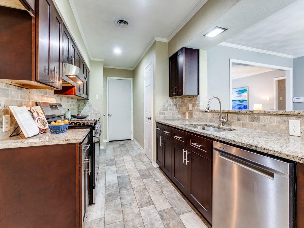 1106 Ridgeway Circle Richardson, TX 75080 - Photo 2 of 25 Kitchen with stainless steel appliances, dark wood finish cabinetry, light stone counters, range hood, and backsplash