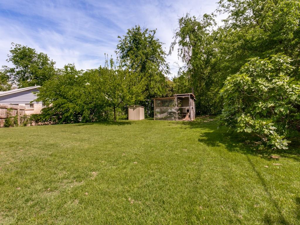 1106 Ridgeway Circle Richardson, TX 75080 - Photo 24 of 25 View of green lawn with a storage unit and exterior structure