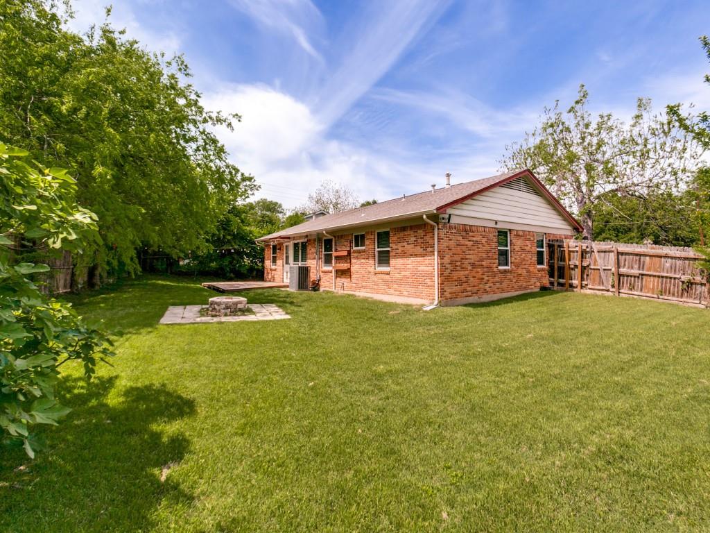 1106 Ridgeway Circle Richardson, TX 75080 - Photo 25 of 25 Back of property with a fenced backyard, brick siding, a patio, and an outdoor fire pit