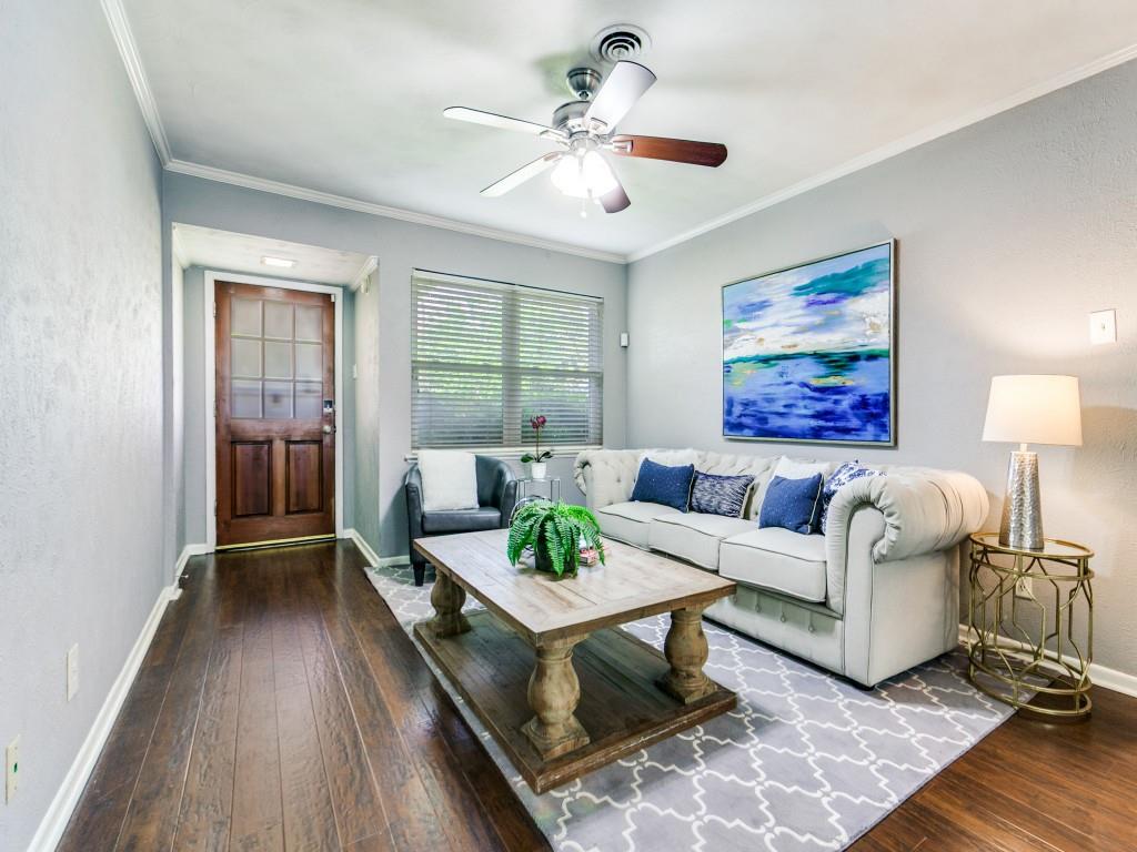 1106 Ridgeway Circle Richardson, TX 75080 - Photo 6 of 25 Living room featuring dark wood finished floors, a textured wall, ceiling fan, and ornamental molding