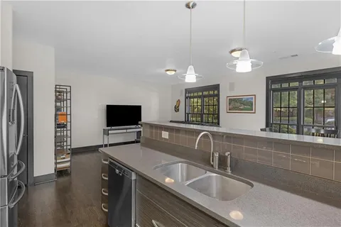 a kitchen with a sink appliances and a window