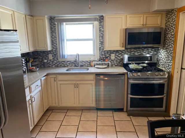 a kitchen with a stove a sink and a microwave