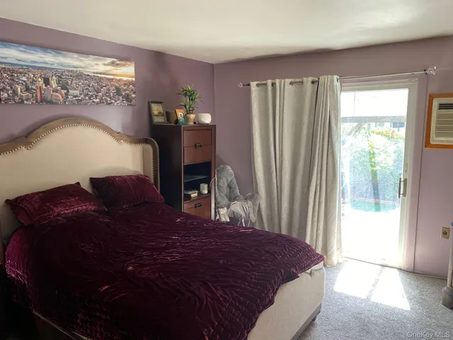 a large bed sitting in a bedroom next to a window
