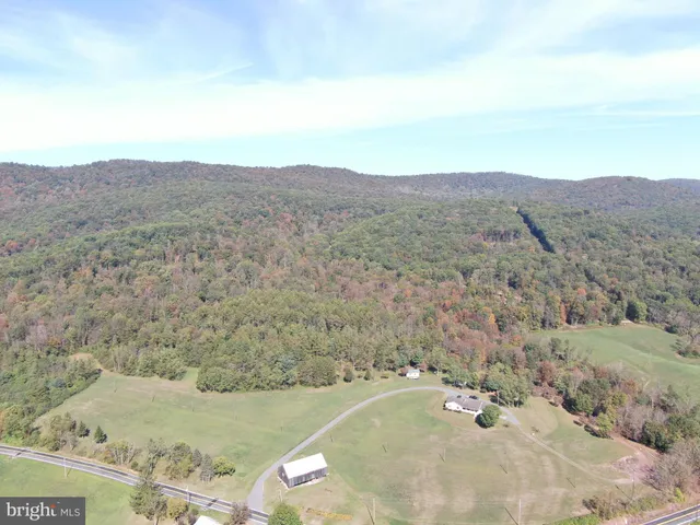 a view of a dry yard with mountains in the background