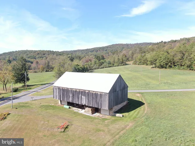 a view of a big yard with an ocean view