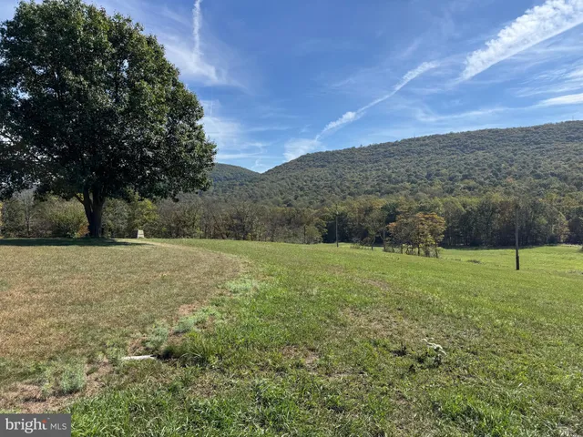 a view of a field with sitting area