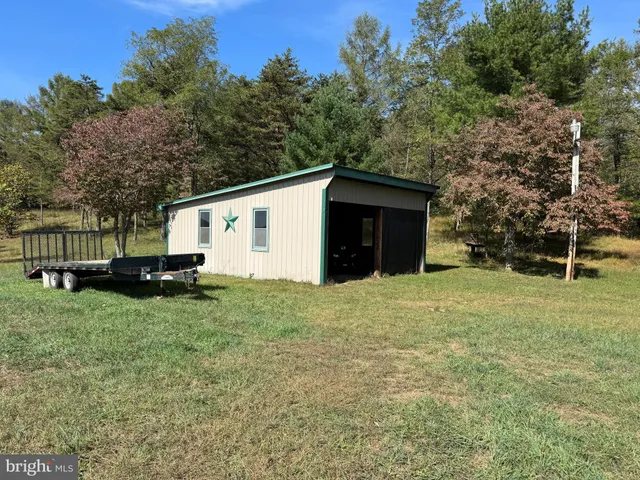 a view of grassy field with mountain