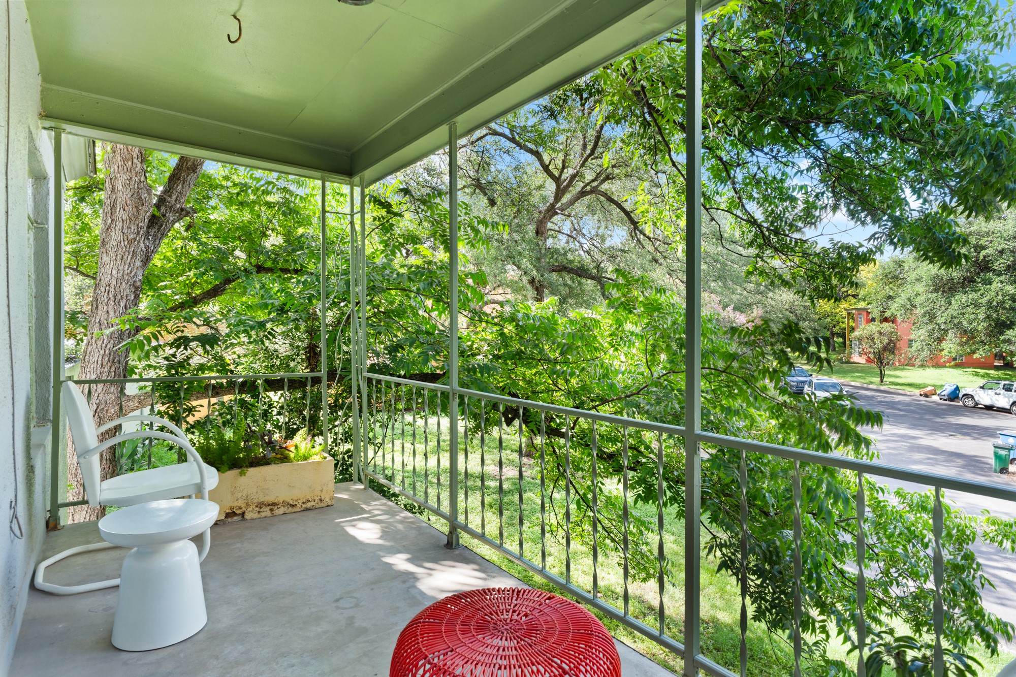 1302 Kirkwood Road, Unit B Austin, TX 78722 - Photo 19 of 21 A tranquil covered porch offers a verdant view of mature trees and the peaceful neighborhood.