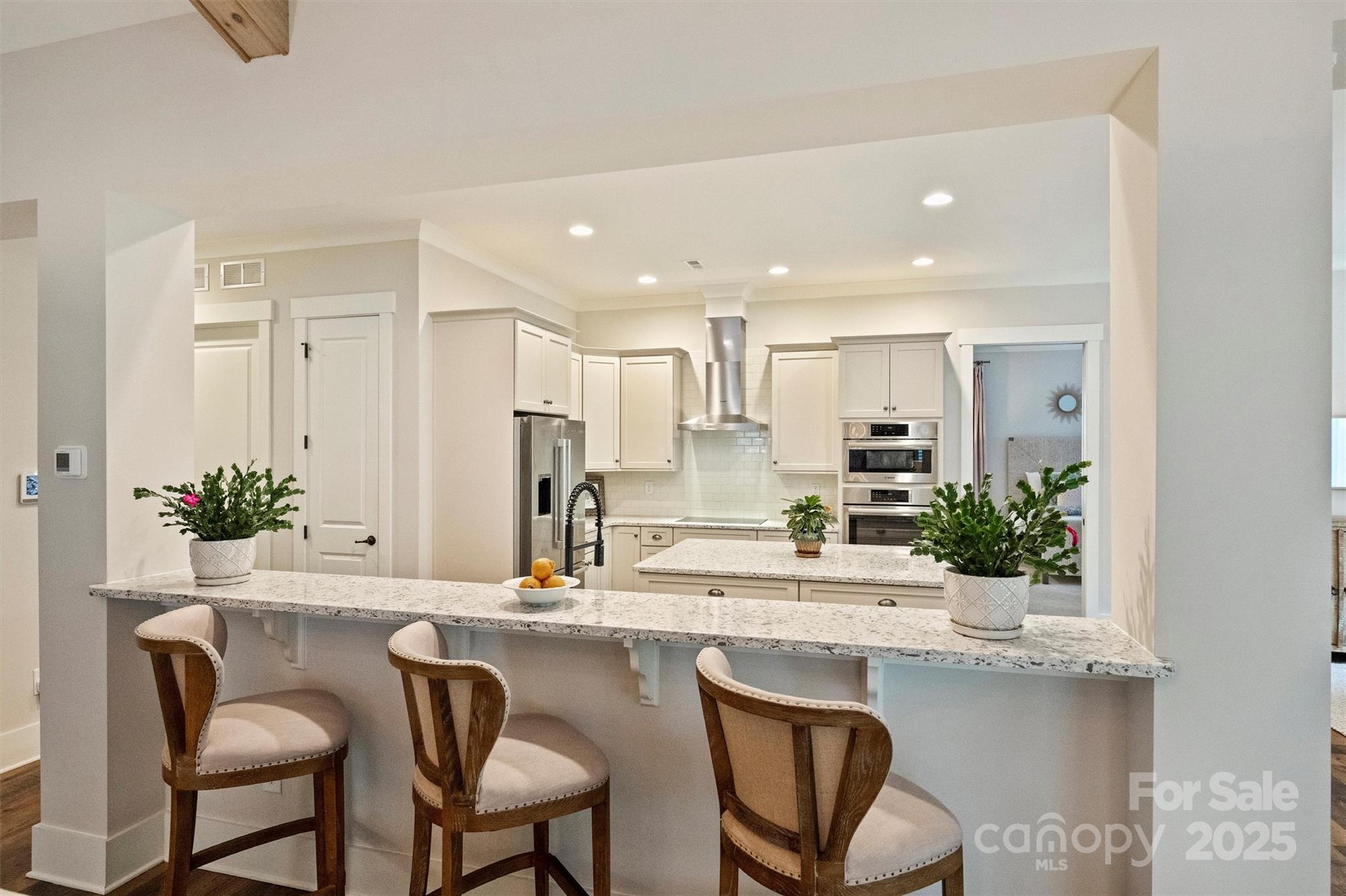 12912 Bailey Road Cornelius, NC 28031 - Photo 11 of 27 a kitchen with kitchen island granite countertop a sink and cabinets
