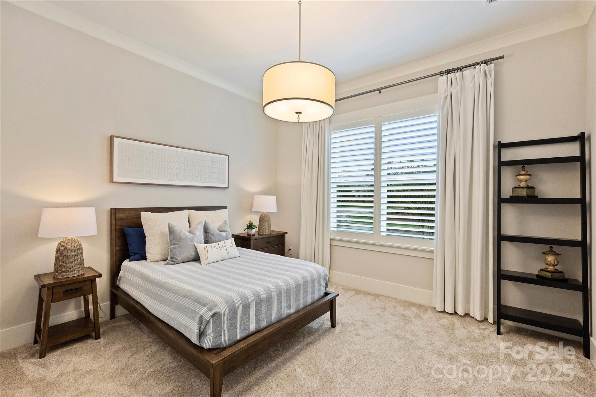 12912 Bailey Road Cornelius, NC 28031 - Photo 4 of 27 a bedroom with a bed and a chandelier