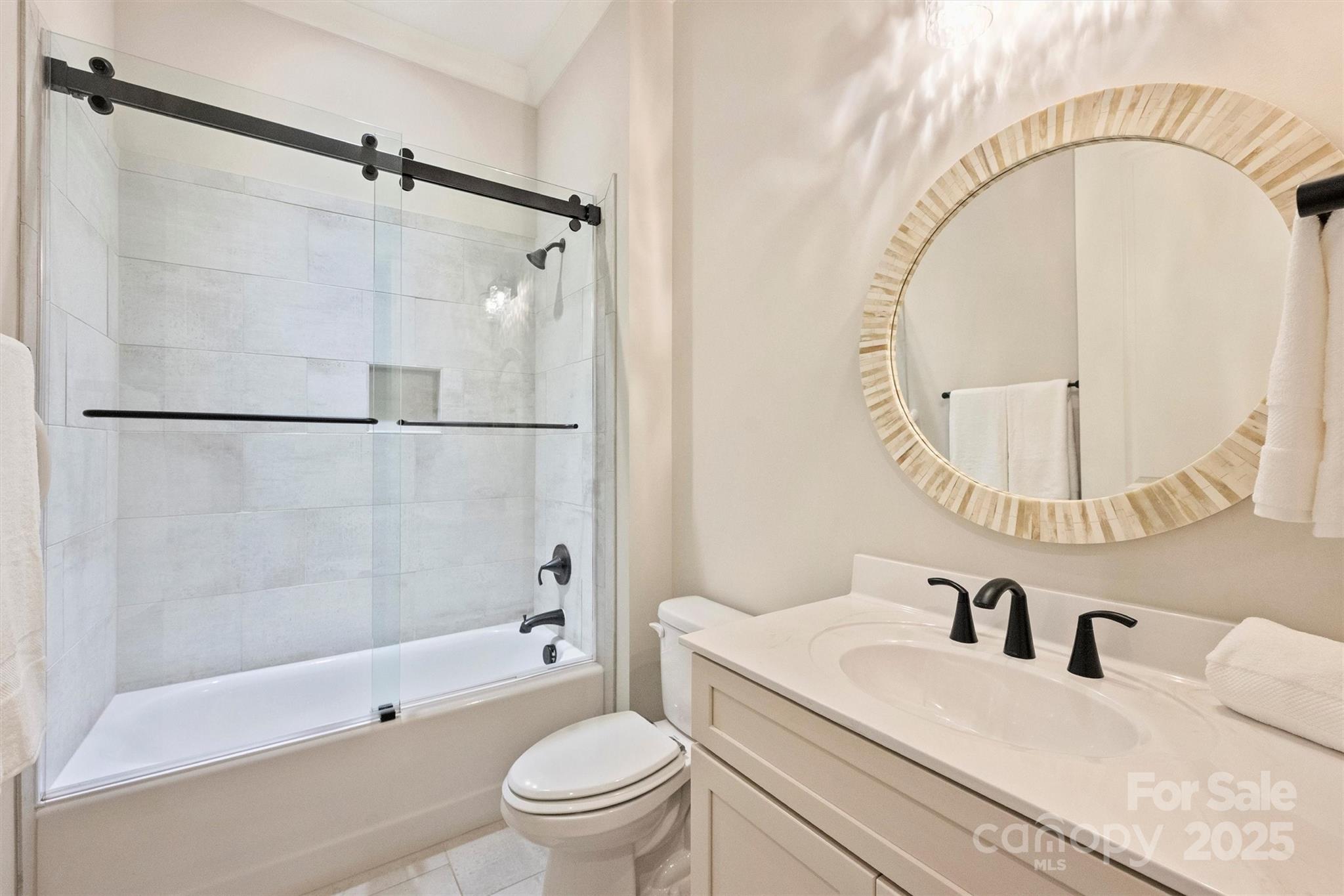 12912 Bailey Road Cornelius, NC 28031 - Photo 5 of 27 a bathroom with a sink a toilet and a mirror