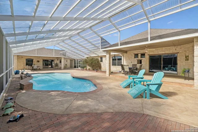 a view of a patio with table and chairs and potted plants
