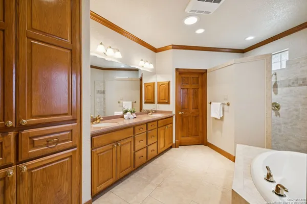 a bathroom with a double vanity sink and a mirror