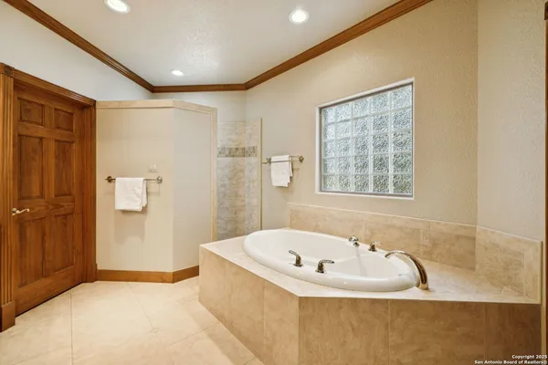 a bathroom with a tub and shower