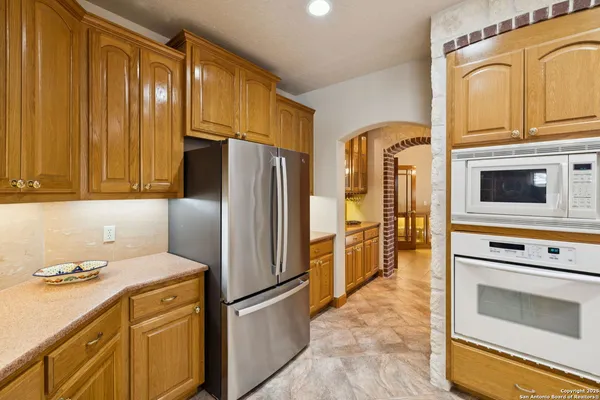 a kitchen with a refrigerator sink and stove top oven