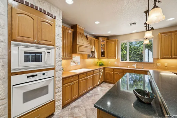 a kitchen with stainless steel appliances granite countertop a stove and a sink
