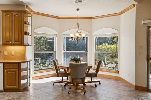 a dining room with furniture a chandelier and a rug