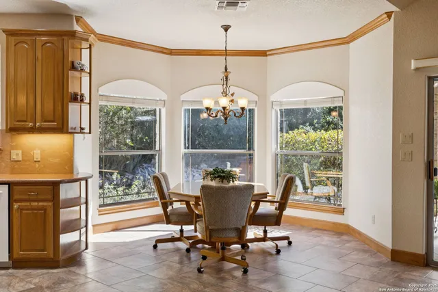 a dining room with furniture a chandelier and a rug