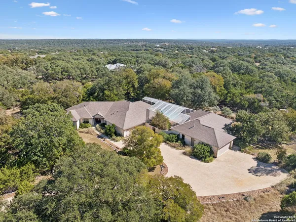 an aerial view of house with yard and mountain view in back