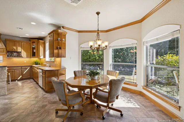 a dining room with furniture a chandelier and wooden floor