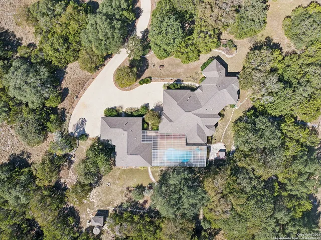 an aerial view of a house with a swimming pool