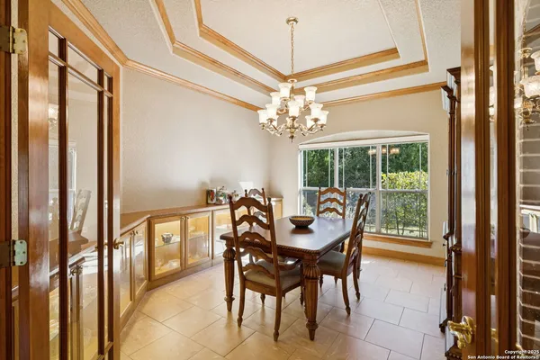 a dining room with furniture a chandelier and fireplace