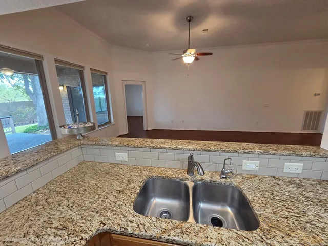 a kitchen with a sink and a mirror