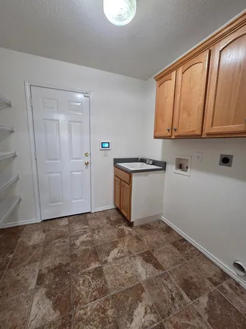 a view of kitchen with white cabinets