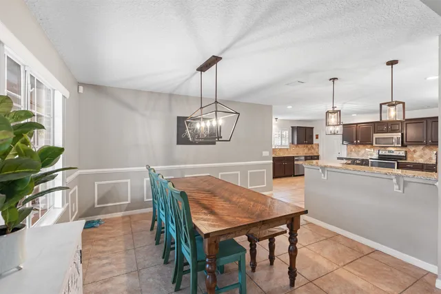 a dining room with furniture and wooden floor