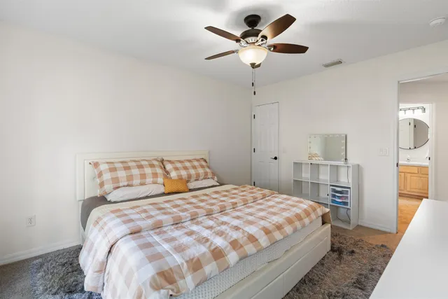 a bedroom with a large bed and a chandelier